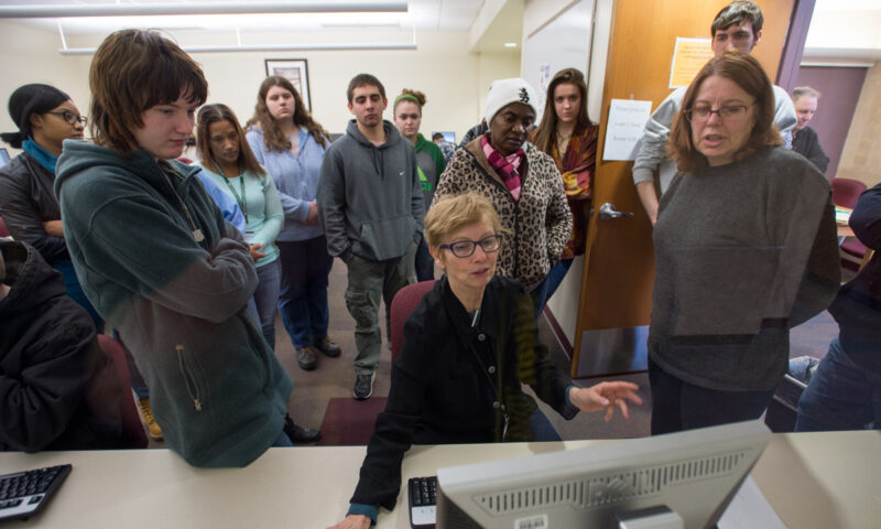 Professor demonstrating on a computer