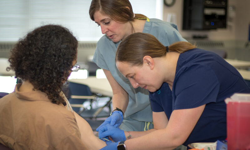 Medical assisting students training on patients