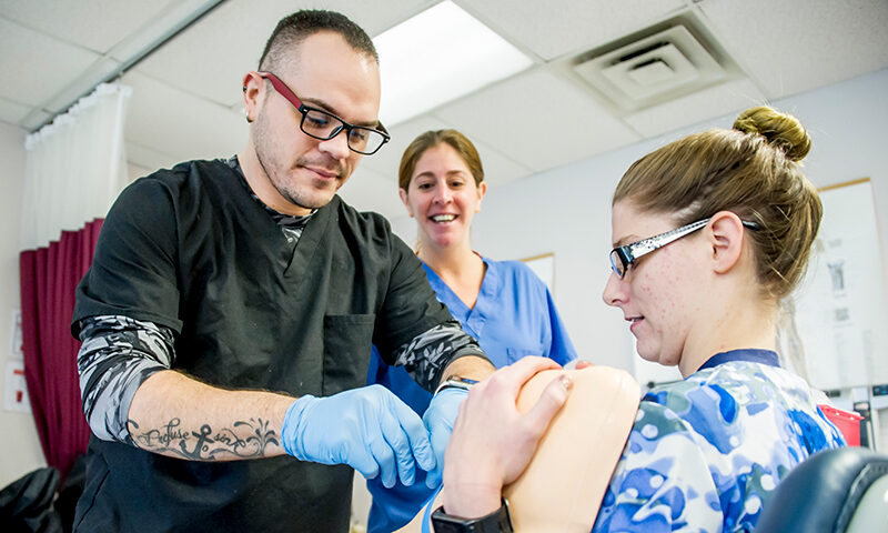 Student practicing skills in nursing lab