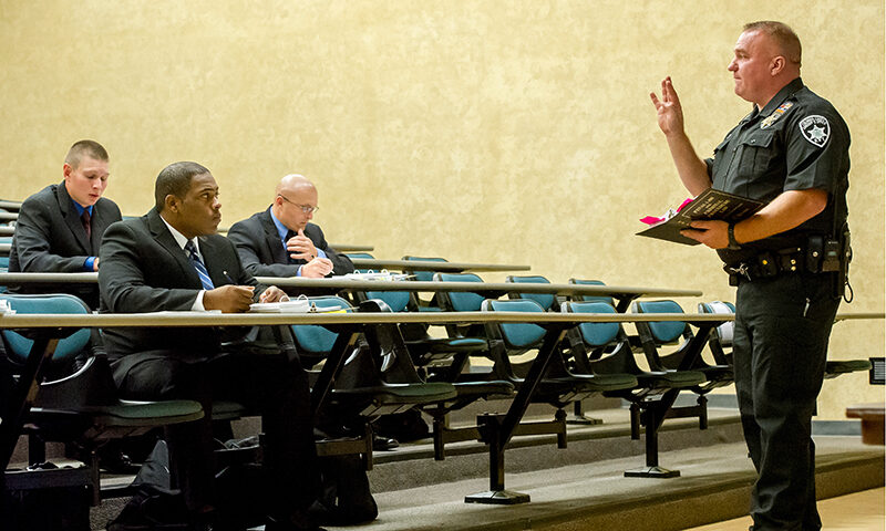 Sheriff instructing class in lecture room