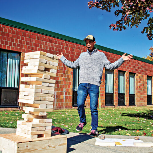 Student takes part in outdoor building block activity